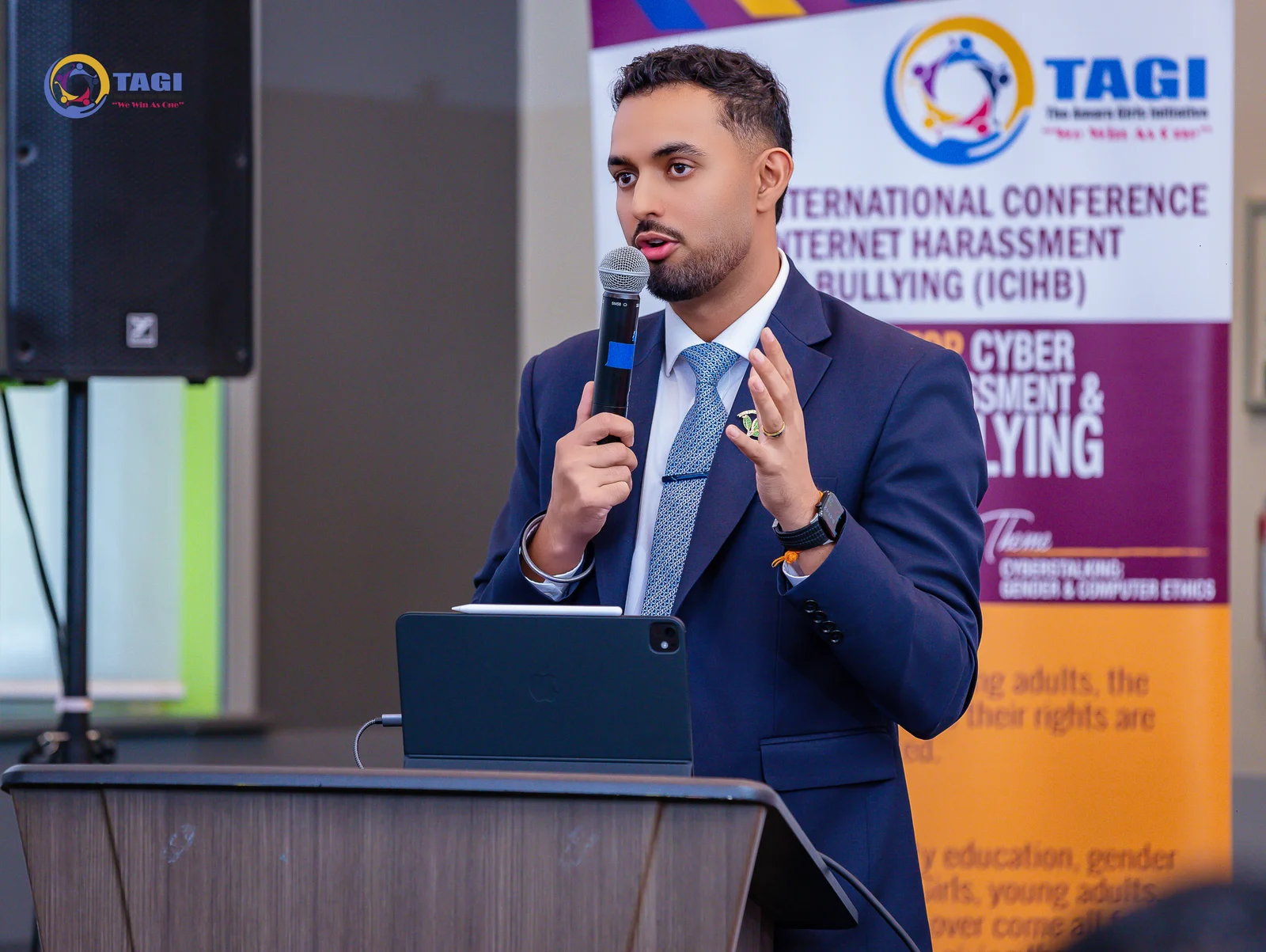 Mr. Dilpreet speaking at the lectern at TAGI Conference 2026