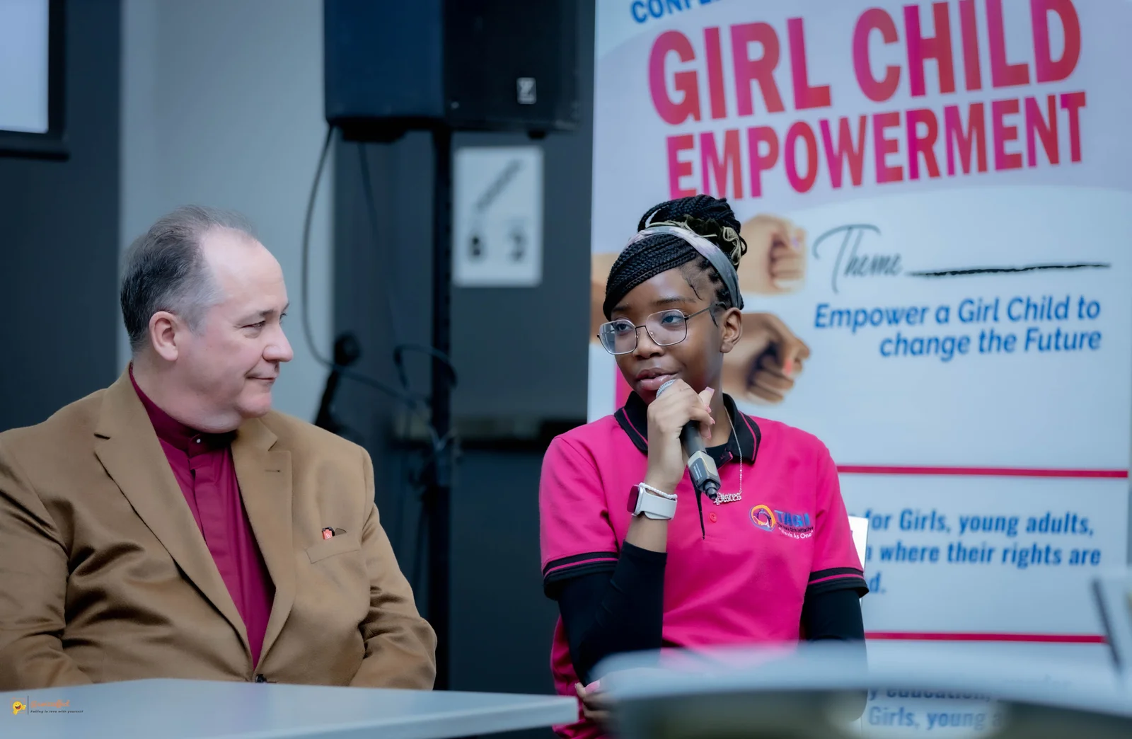 Namara Chloe speaking into a microphone at TAGI Conference 2026