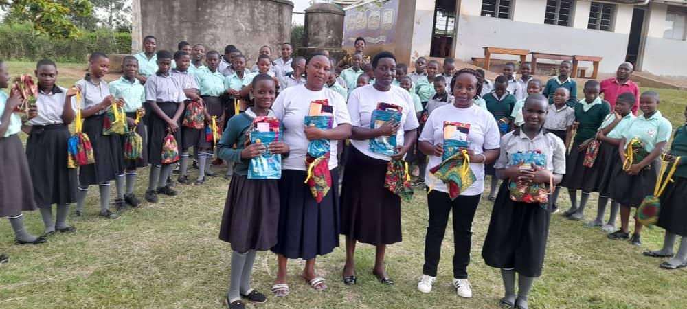 Students and facilitators gathered outside a school with supplies